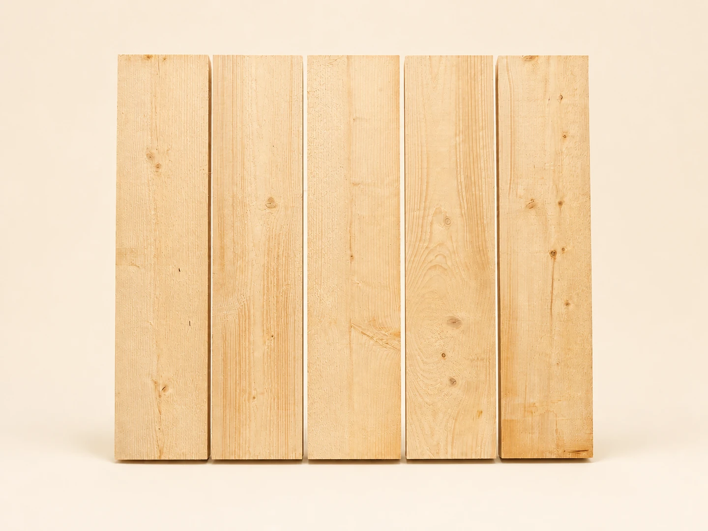Five unmarked pale timber target boards arranged side by side on ivory