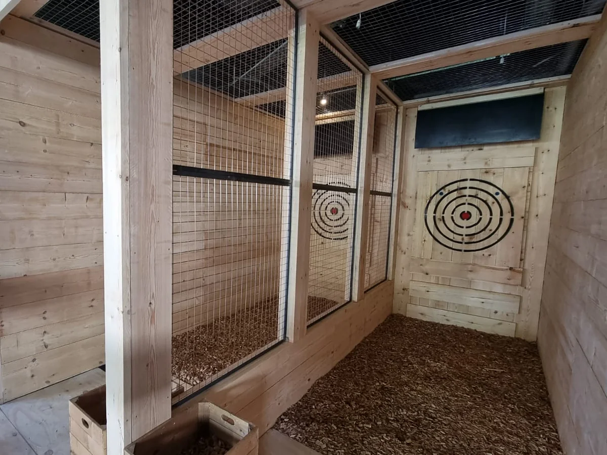 Close view inside a traditional commercial throwing lane with timber target and mesh containment